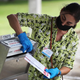 A poll worker places Vote-by-Mail ballots into an official ballot drop box set up at the Election Headquarters polling station on October 19, 2020, in Doral, Florida.